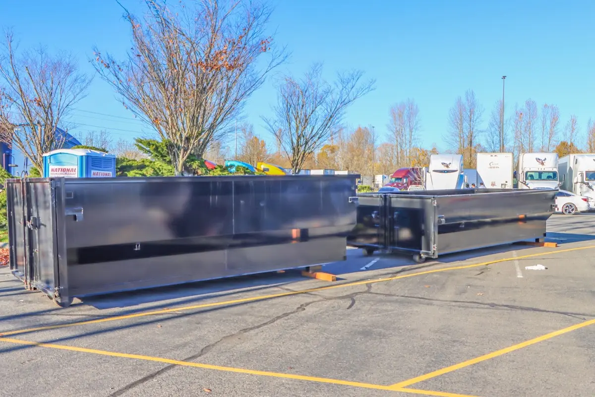 Professional dumpster rental service with roll-off container on residential driveway in Manheim